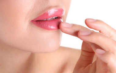 Naklejka premium Woman with beautiful pink lipstick on her lips against white background, closeup