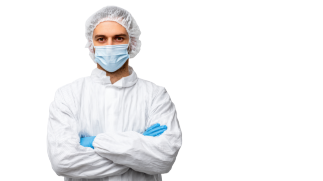 Male medical professional in protective gear, posing confidently with arms crossed, on isolated background.