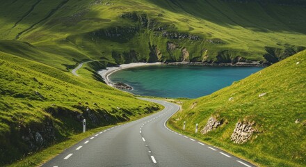 Scenic road winds through green hills towards a serene bay under bright daylight perfect for travel concepts