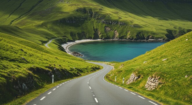 Scenic road winds through green hills towards a serene bay under bright daylight perfect for travel concepts