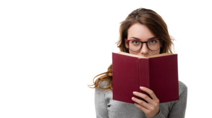 Woman reading a book while wearing glasses, focused and immersed in literature.
