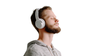 Young man enjoying music with headphones, eyes closed, peaceful expression, isolated on a white background.