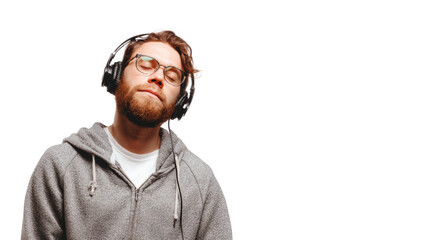 Young man enjoying music with headphones, closed eyes, relaxed expression, casual attire, white isolated background.
