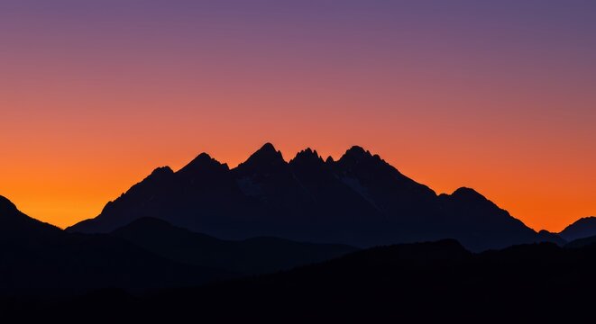 Silhouette of mountain range against colorful sunset sky dramatic scenic view natural landscape