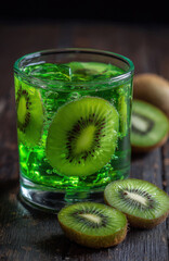 Green kiwi jello in a glass on a dark wooden table