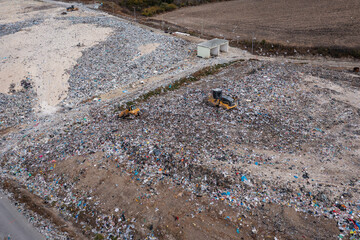 Arial view of excavator working with trash on rubbish dump