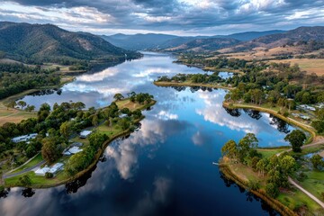 Fototapeta premium Aerial view of a serene lakeside village at sunset