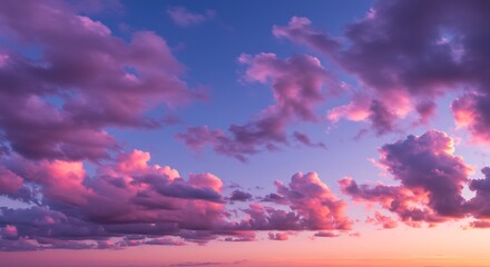 Vibrant pink and purple clouds at sunset or sunrise in the sky