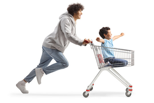 Fototapeta Father pushing a boy inside a supermarket shopping cart