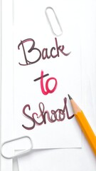 Handwritten "Back to School" note with pencil and paperclips