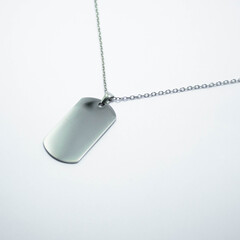 Fototapeta premium Silver pendant on a chain isolated on a white background. Concept of jewelry catalog photography, fashion accessory, minimal design, and elegant gift ideas