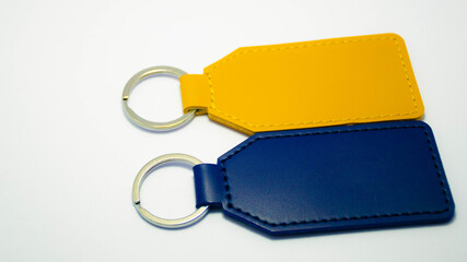 Set of colorful rectangular leather keychains with metal rings isolated on a white background. Concept of personalized accessories, engraving blanks, handmade crafts, and custom gift ideas