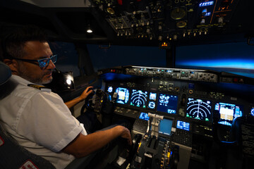 Naklejka premium Commercial airline pilot flying airplane in flight simulator