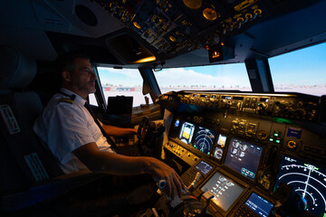Commercial airline pilot navigating flight simulator cockpit instruments © Martí Rosselló