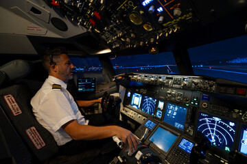 Airline pilot training on a flight simulator at night © Martí Rosselló