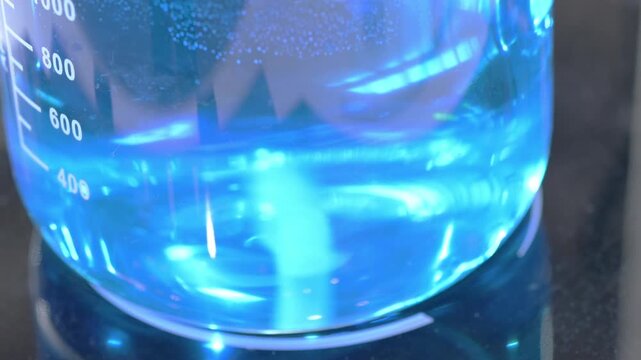 Magnetic stirrer mixing blue liquid in beaker