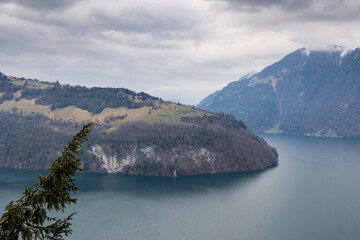 Cloudy Day View of Swiss Lake and Steep Mountain Shoreline