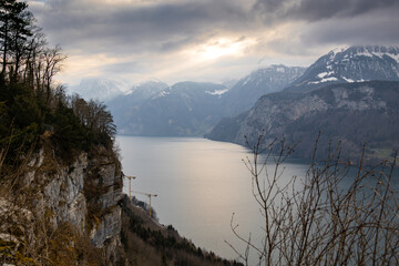 Dramatic Mountain Lake Landscape with Sun Breaking Through Clouds