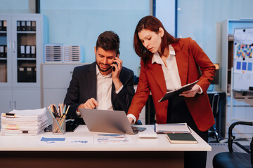 Business team working on a project in the office or reviewing and discussing a business project.