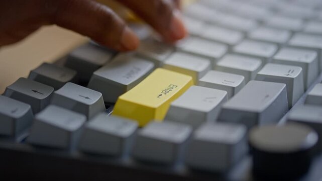 Extreme close-up of hands and fingers of anonymous young black woman with neat natural nail manicure pressing backspace key on desktop computer keyboard while writing or editing text