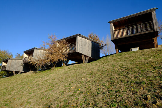Siloe monastery guesthouse modern wooden cabins on hillside, Grosseto province Italy