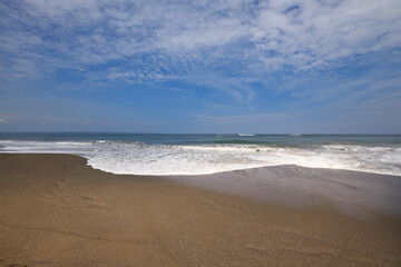 The beach is empty and the sky is clear