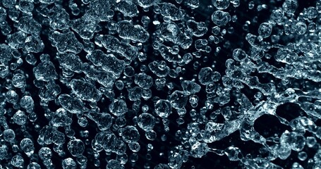 Freeze Motion of Blue Water Drops Splashing up in the Air. Abstract Aqua Drinks Background. Isolated on Black Background.