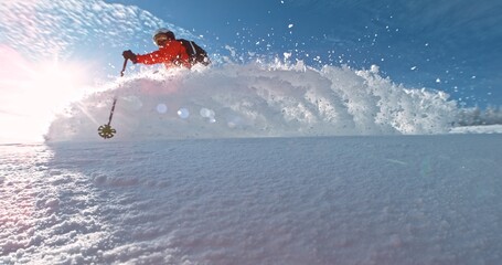 Freerider running in fresh snow. Freeride skiing in deep powder snow. Chest deep snow during snow storm. Funny skiing, rides over off-piste