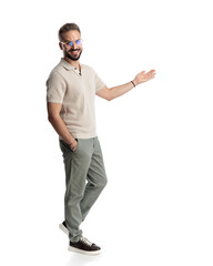 side view of handsome man with glasses presenting to side and smiling