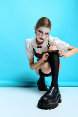 Beautiful young woman showcases Halloween costume with spooky charm and unique style