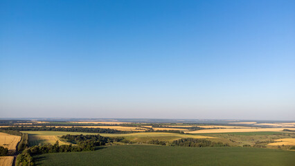 Aerial rural summer scenery with green agriculture fields and blue sky