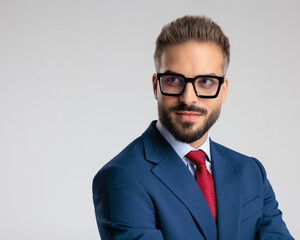 attractive elegant man with black eyeglasses looking away and smiling