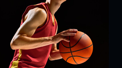 Basketball player close up with ball focus and emotional concentration. Concept of sports branding, motivation posters, fitness advertising, and youth training visuals.