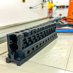 Close-up of a black electrical junction box with multiple connections