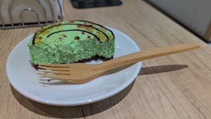 A Beautiful and Delicious Green Dessert Plated Elegantly Alongside a Wooden Fork