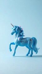 Light Blue Unicorn Toy with Pink Mane and Horn on Soft Blue Background Cute Animal Equine Fantasy Theme