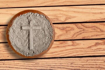 cross on grey ash, dust in plate, christian religion