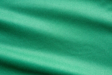 Green sports clothing fabric football shirt jersey texture close up