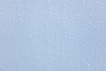 A close up of a wet surface with many small droplets of water