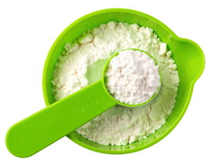 Flour in a green measuring cup and spoon