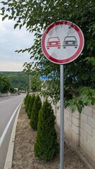 This sign indicates a designated no overtaking zone for vehicles and traffic regulations