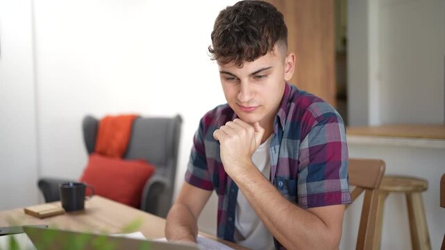 Young thoughtful student studying at home
