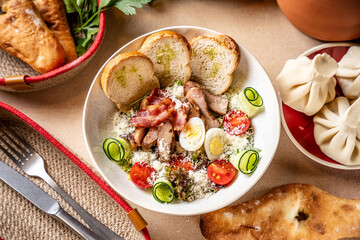 Caesar salad with chicken, eggs and bread