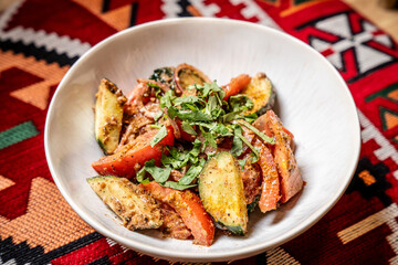 Georgian vegetable salad on ethnic tablecloth