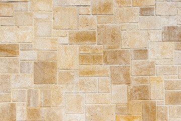 Travertine, natural stone tiles, perfect for a background, creating a unique and aesthetic pattern of yellowish-beige rectangles of various sizes