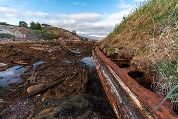 old abandoned sunken ship in the water at the ship cemetery