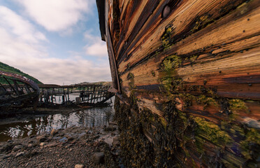 old abandoned sunken ship in the water at the ship cemetery