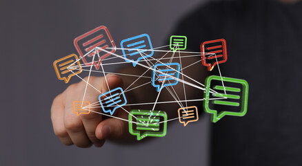 Conceptual image of hand reaching out to colorful speech bubbles connected by lines, symbolizing...