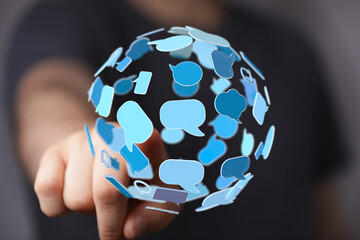 Modern communication technology shown by speech bubbles on a sphere. Connection and global dialogue...