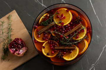 Festive holiday punch with oranges, pomegranates, and rosemary prepared for Thanksgiving and Christmas gatherings
